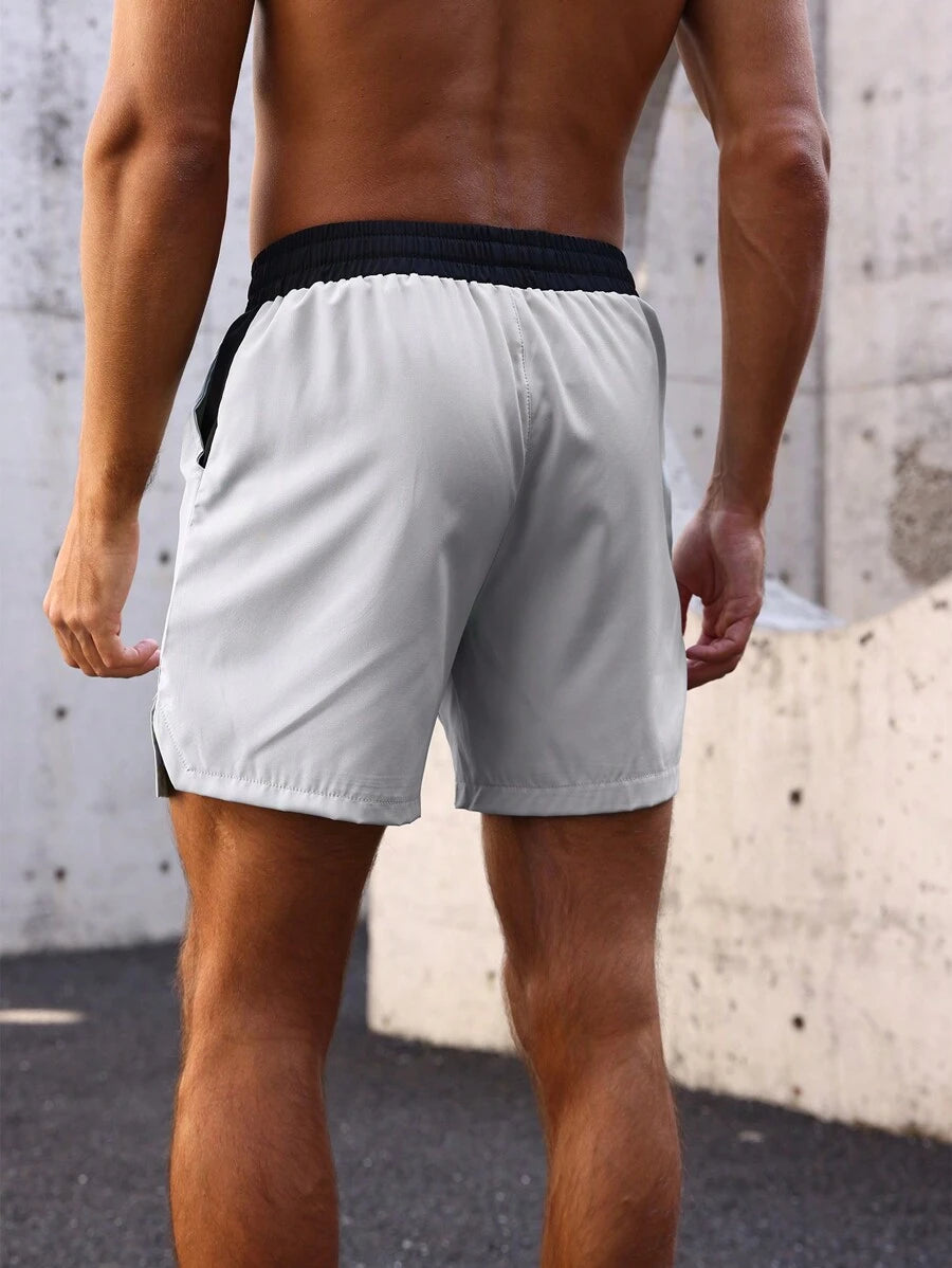 Shorts de sport avec taille élastique, poches larges et inscription