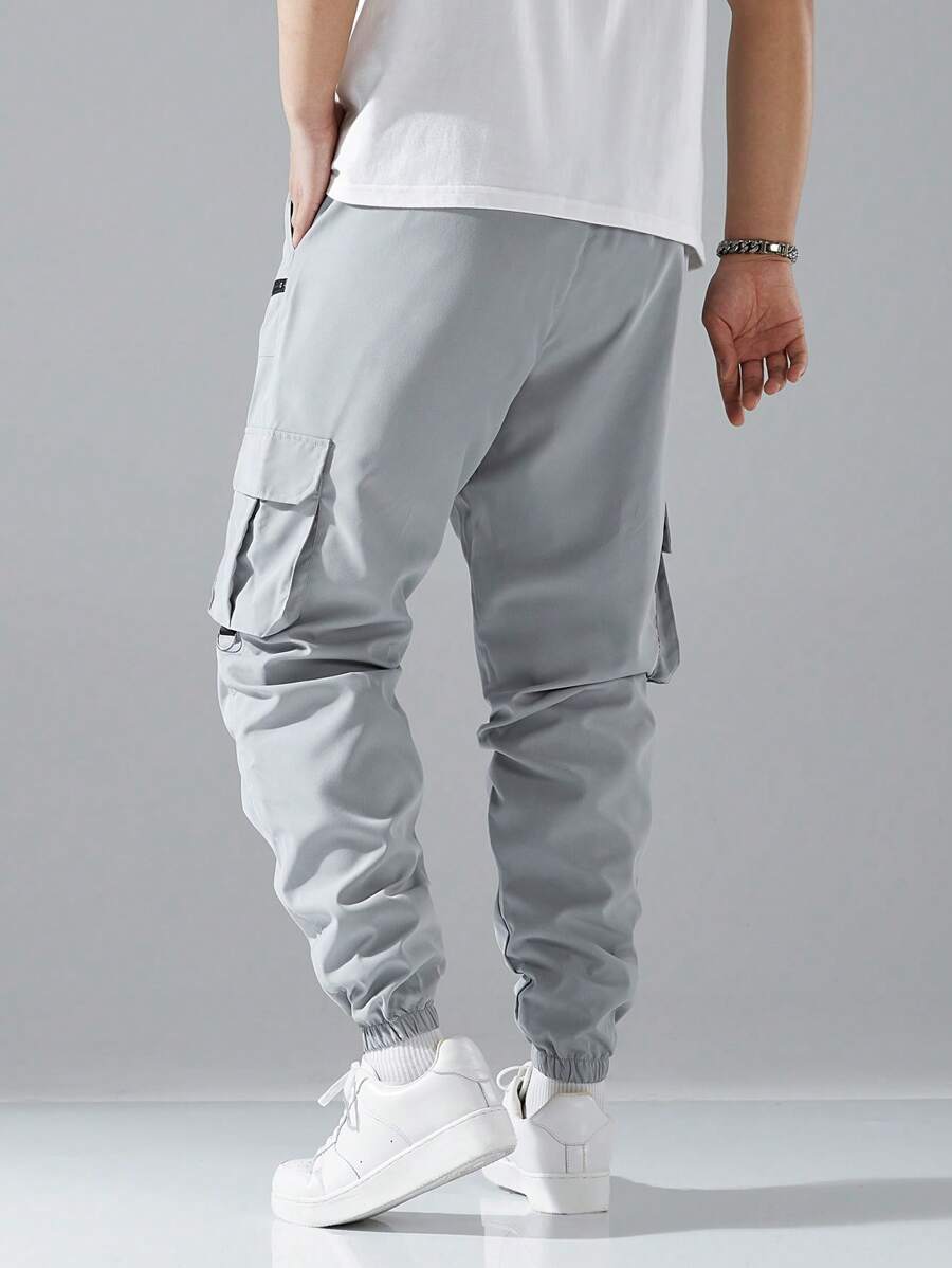 Pantalon cargo ample avec poches à rabat et cordons de serrage pour homme