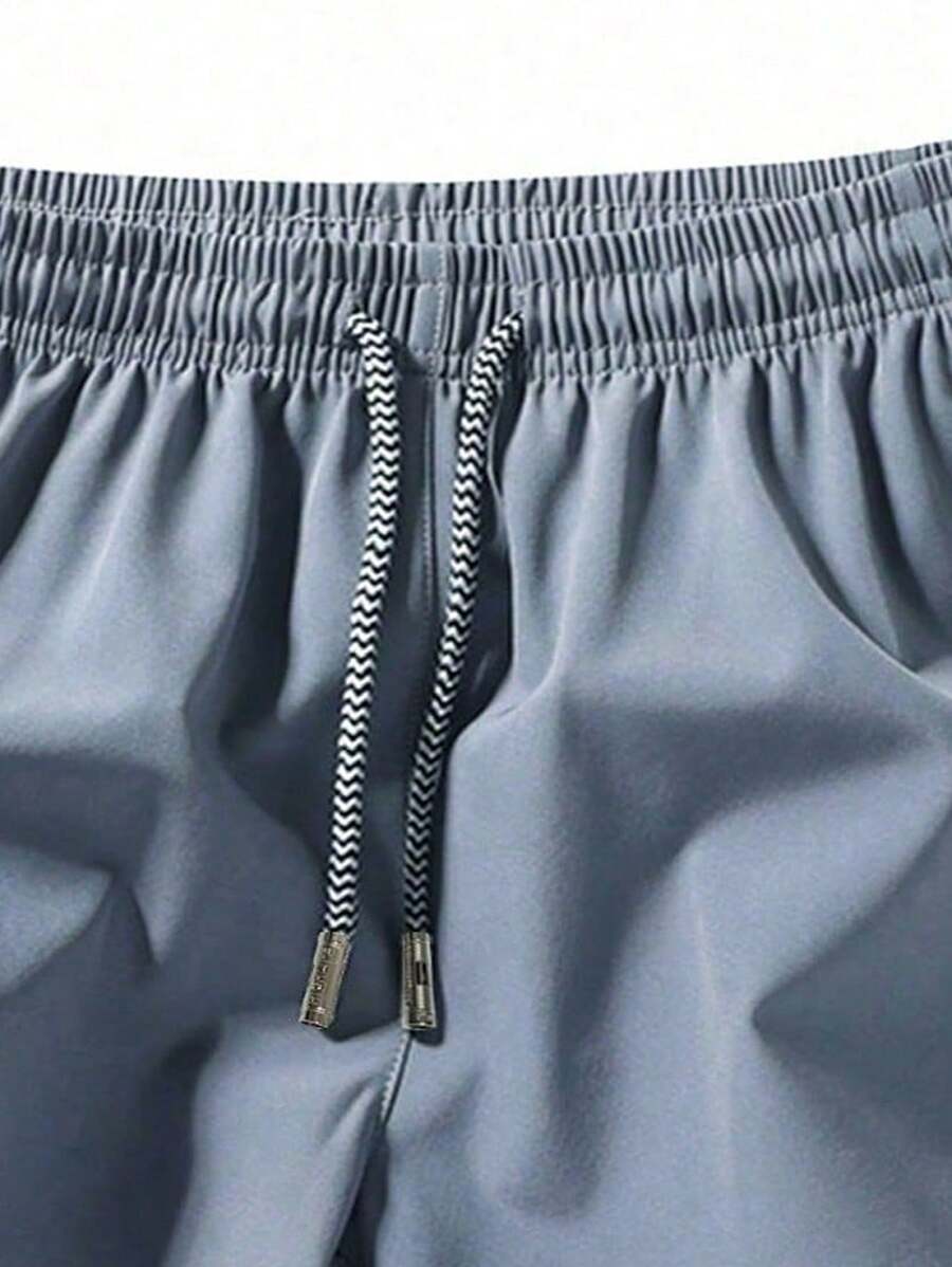 Shorts de sport taille élastique avec poches zippées et cordon