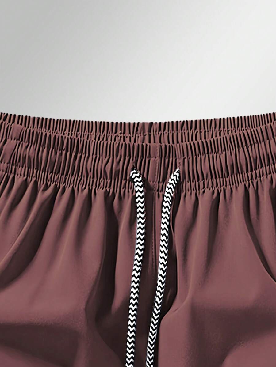 Shorts de sport taille élastique avec poches zippées et cordon