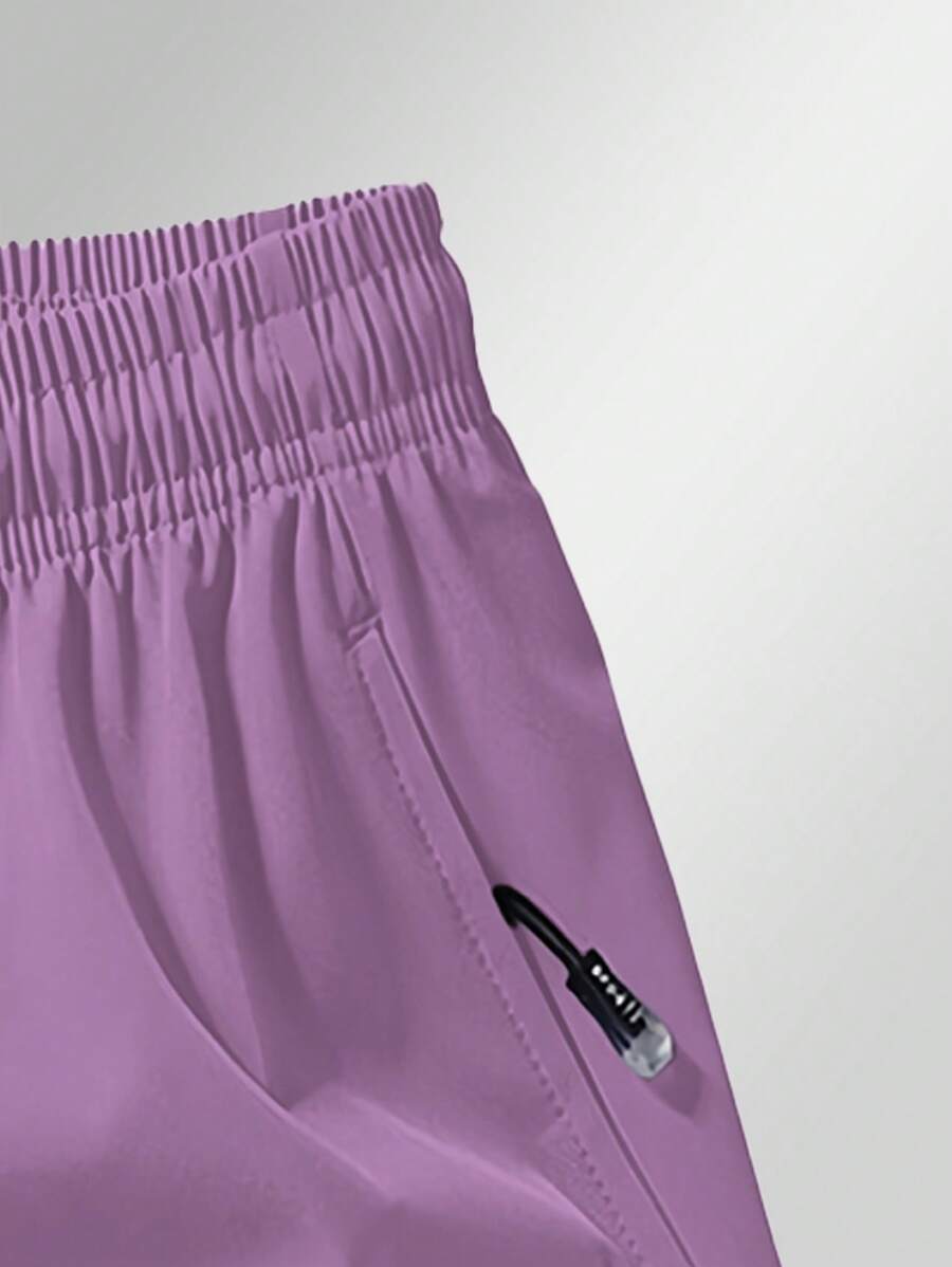 Shorts de sport taille élastique avec poches zippées et cordon