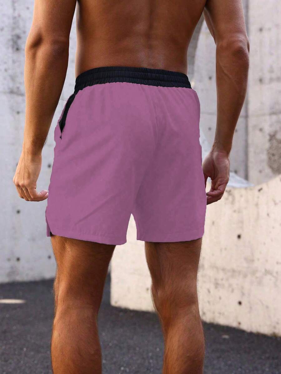 Shorts de sport avec taille élastique, poches larges et inscription