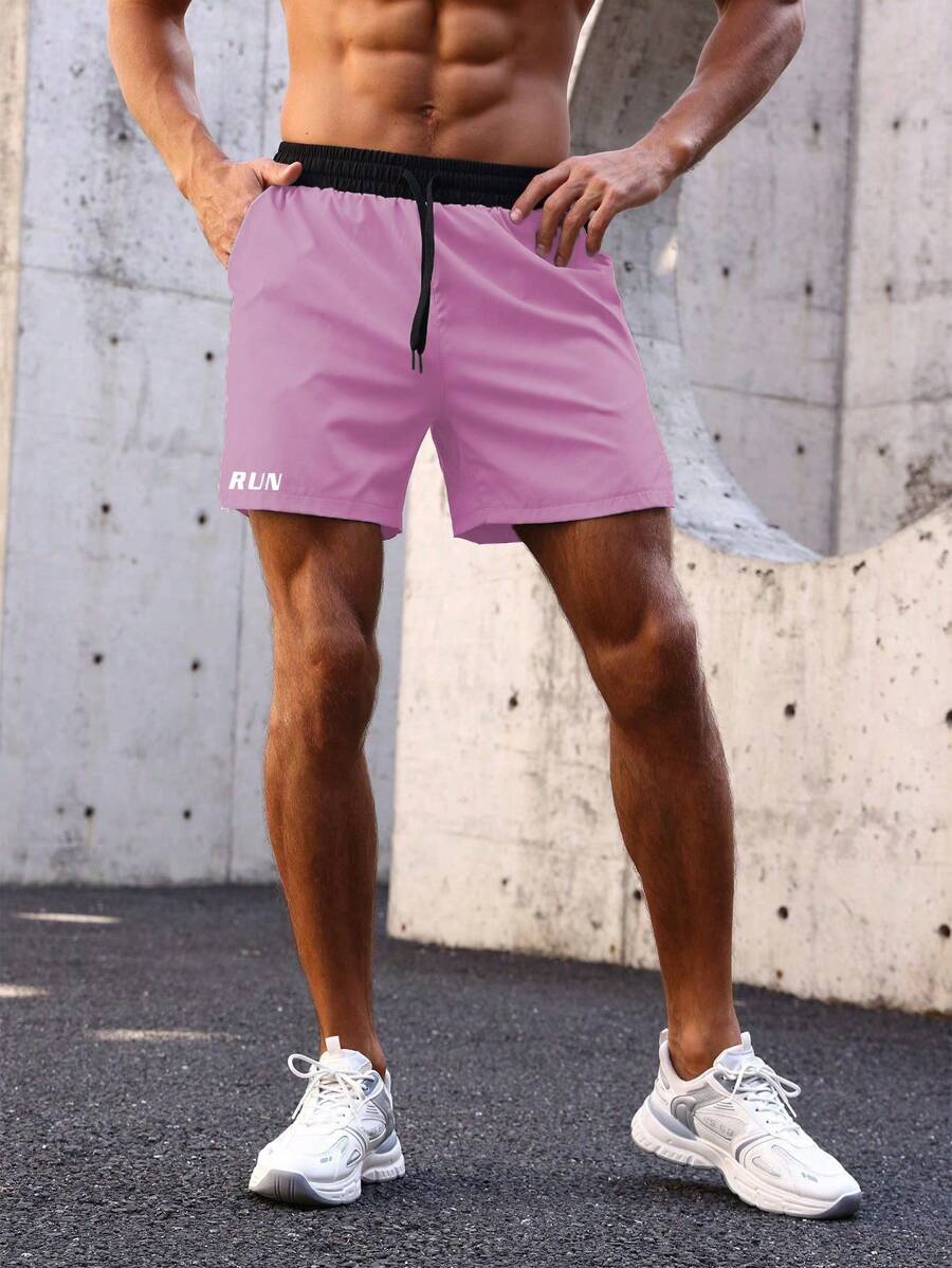 Shorts de sport avec taille élastique, poches larges et inscription