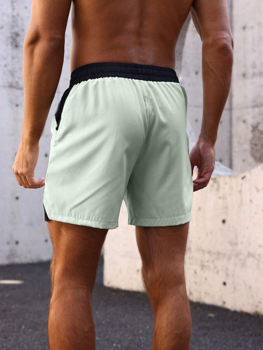 Shorts de sport avec taille élastique, poches larges et inscription