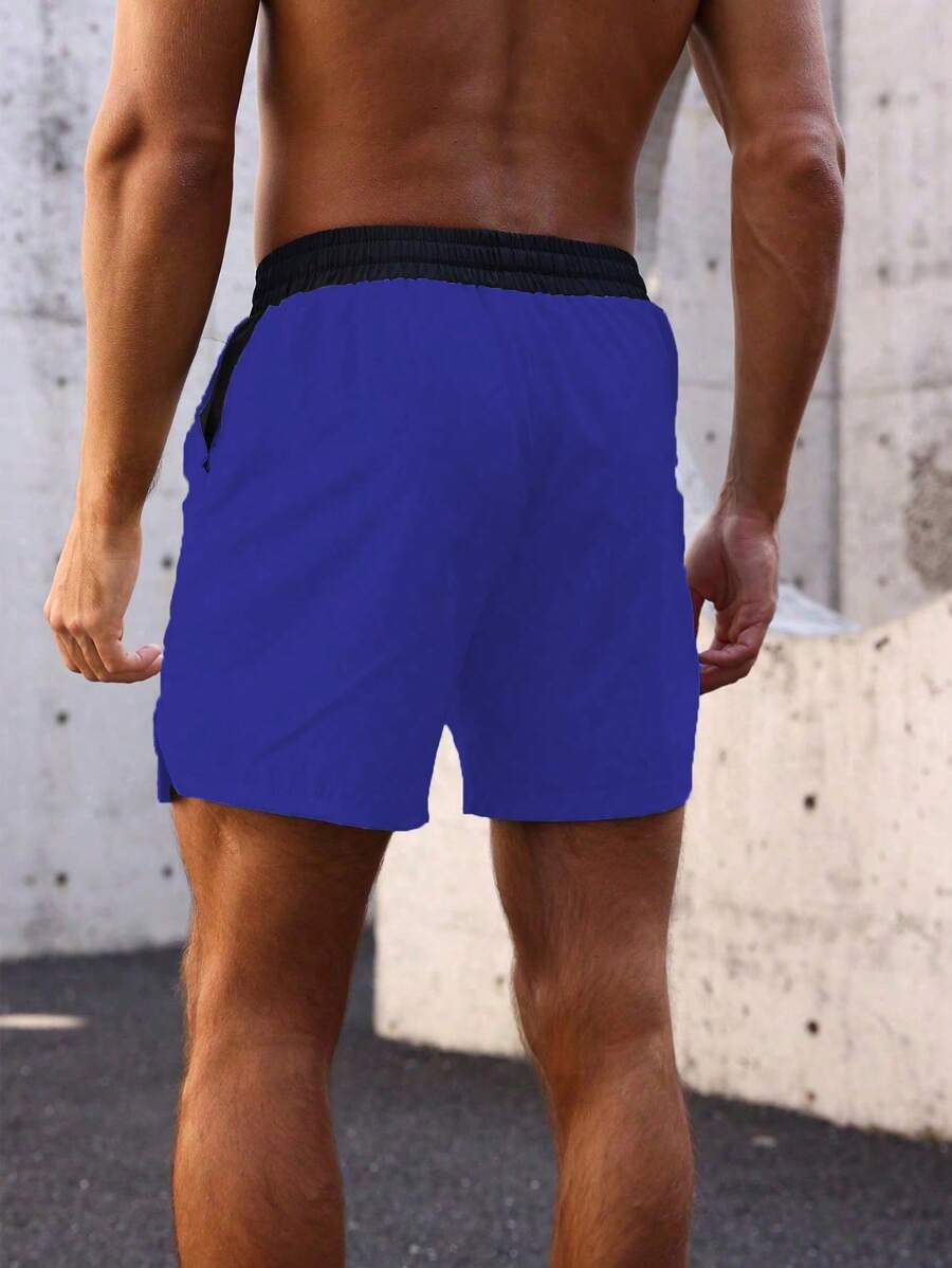 Shorts de sport avec taille élastique, poches larges et inscription
